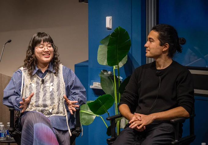 two people sit in front of auditorium