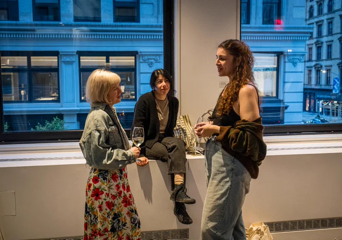 three people sit and chat