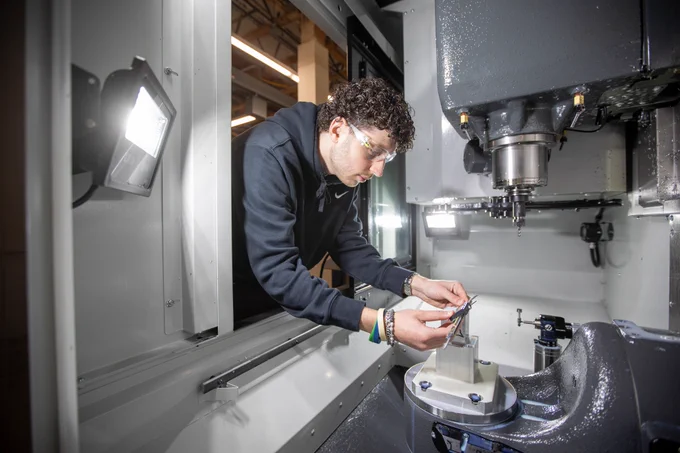 An SPSCC Machining Technologies student operating the 5-axis CNC milling machine