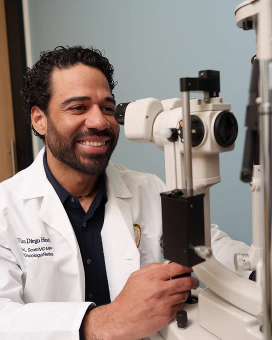 Photo Description: Nathan L. Scott, MD, MPP examining patient using slit lamp.