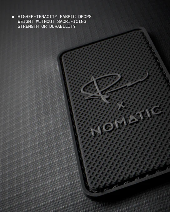 Close-up of the lightweight, high-tenacity fabric and NOMATIC rubberized logo patch on the new professional creator gear backpack.