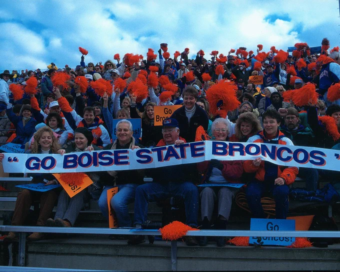 Boise State football fans from the 90s cheering in the stands. 
