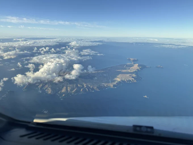 The island of Porto Santo, Madeiras much smaller neighbor. Clear of clouds for the most part with the airport bisecting the island towards us. Some clouds over the eastern part.