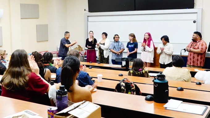 At the History Research Symposium on May 8, 2026, from left is Professor of History Yucheng Qin leading applause for new honor society members Nicole Scott, Briana Gaylord, Antonio Miguel Vite, Kameron Kecher, Madison Johns, Sean Estavillo, and Benney Lat, Jr. (Photo: Haukea Valdez/History Dept/UH Hilo)