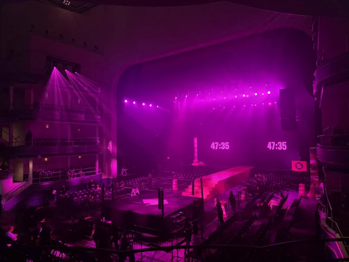 A view of the Sukeban ring, ramp and entrance set up inside of Hammerstein Ballroom. The ballroom is coated in a pink light.