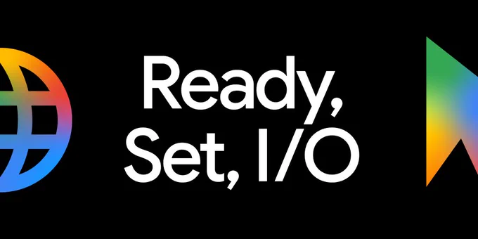 A black background featuring the white text "Ready, Set, I/O" in a sans-serif font. To the left is a multi-colored, stylized partial globe icon, and to the right is a multi-colored arrow icon pointing upward, both showcasing a gradient of vibrant colors.