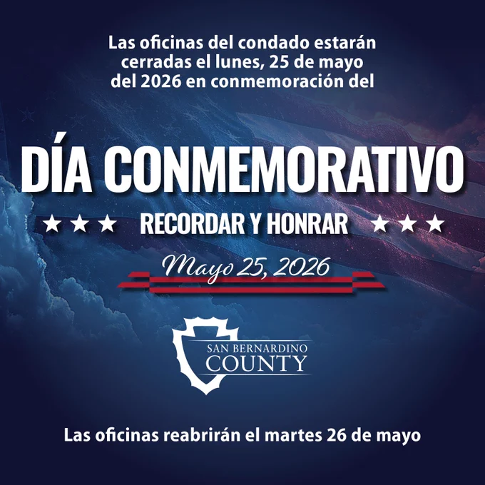 La imagen anuncia que las oficinas del condado de San Bernardino permanecerán cerradas el Día de los Caídos, 25 de mayo de 2026, y reabrirán el martes 26 de mayo de 2026. Se aprecia un fondo con nubes y una bandera de los Estados Unidos.
