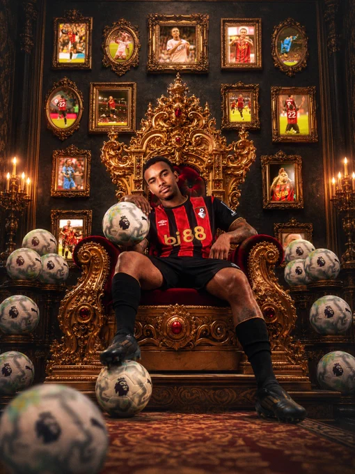 Junior Kroupi sits on the throne surrounded by footballs and pictures.