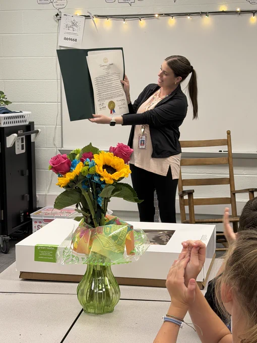 Mrs. Foster shows her class the proclamation in front of the classroom.
