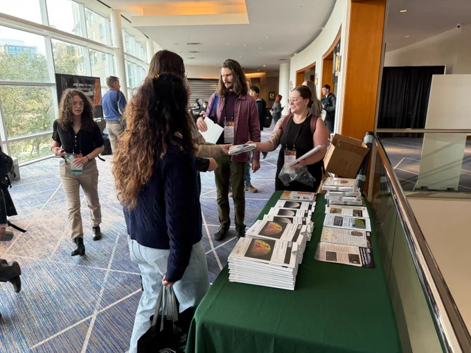 USGS Geographer Sonya Bogle handing out maps at the USGS booth at LPSC