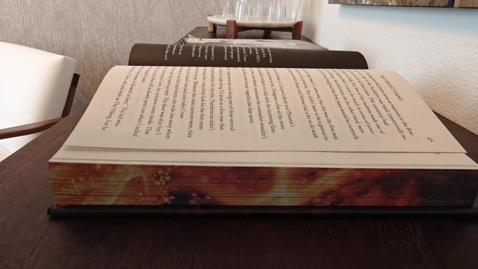 Sprayed edges; fire on the side and bottom, black plumes of smoke on top.