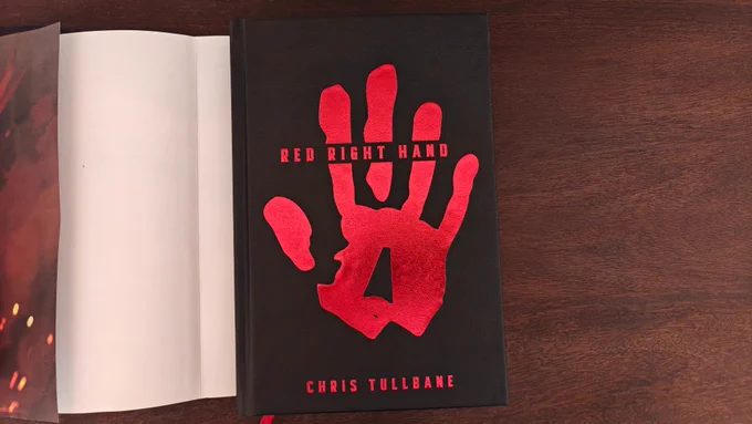 The black vegan leather cover with a foiled red handprint.
