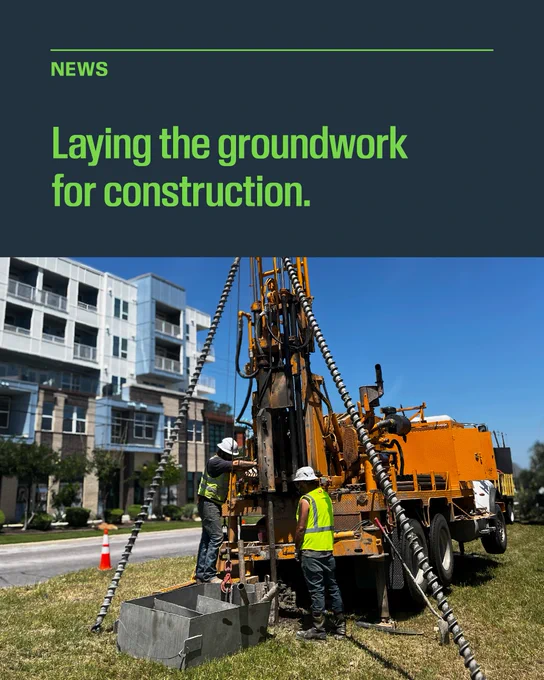Green text on a navy background reads, "News: Laying the groundwork for construction." Below the headline, an image shows two construction workers using a piece of machinery in a median. 