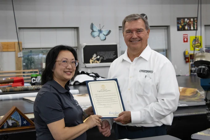 Missouri Department of Labor and Industrial Relations Director Anna Hui awards Craftsman Industries CEO and owner Mark Steele the governors certificate of recognition for their SHARP achievement.