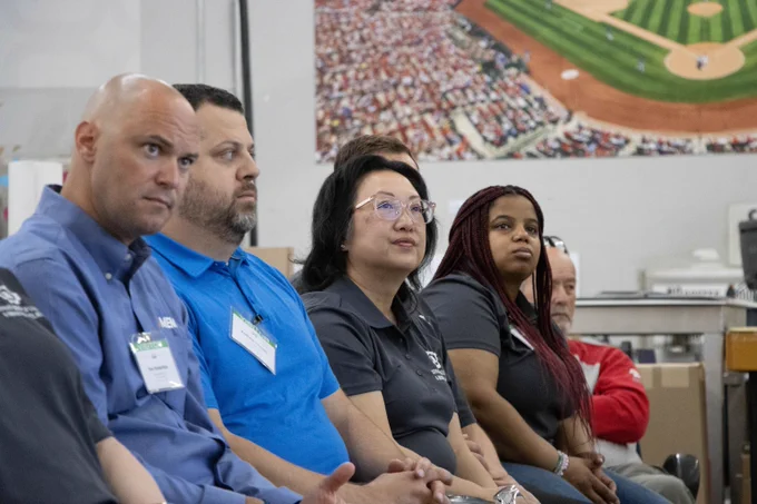 Crowd listening to SHARP ceremony speakers. From Left to right: Dan Rodenfels, Andrew Grosch, Director Anna Hui, and Lauren McGee