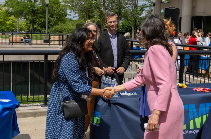 Governor Gretchen Whitmer shaking hands with State of Michigan employees.