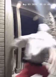Possible thin male with a gray hoodie, red jogger pants, and slides/sandals