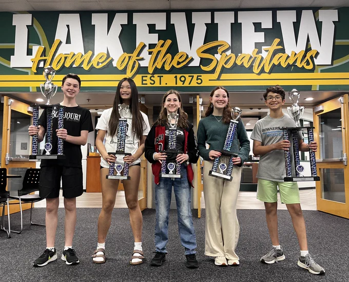 8th graders holding their trophies in the lakeview lobby