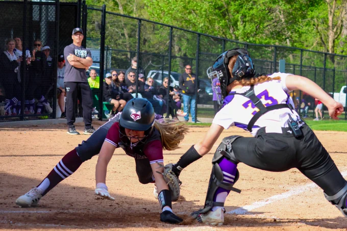 Knocking the ball loose as she scores for the Foxes.