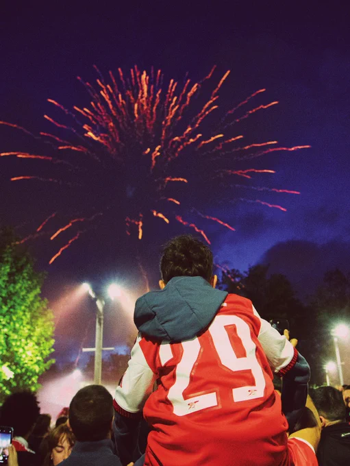 A young supporter looks on at fireworks outside Emirates Stadium.
