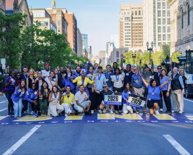 Image of members of the 2026 Boston’s Marathoners and Medley to Marathon participants posing for a photo at the Boston Marathon Finish Line