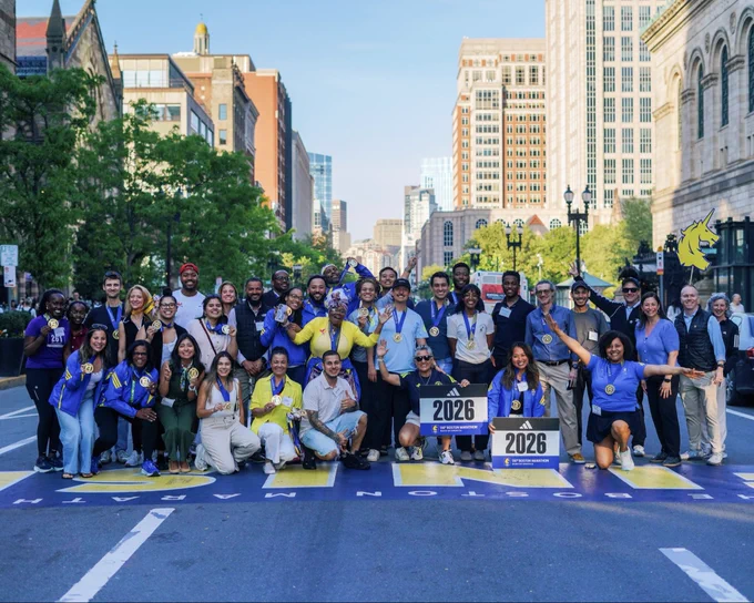 Image of members of the 2026 Boston’s Marathoners and Medley to Marathon participants posing for a photo at the Boston Marathon Finish Line