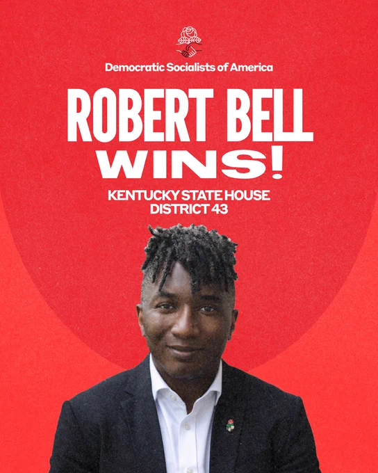 Robert Bell Wins! Kentucky State House District 43.
Robert Bell pictured wearing a black blazer, white button up shirt with the top button undone, and DSA lapel pin proudly displayed.