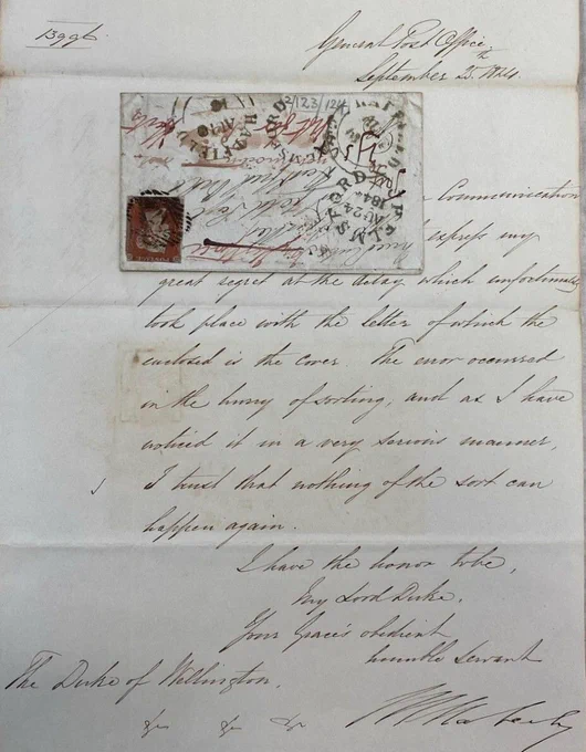 handwritten letter on pale beige paper. There is an envelope stuck on the page, upsidedown
