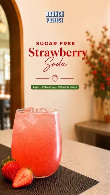 A vibrant Sugar Free Strawberry Soda served at The Brunch Project café in Koramangala, Bangalore. The image features a glowing pink sparkling soda in a modern rounded glass filled with ice cubes and tiny fizzy bubbles, placed on a neutral-toned café table with fresh strawberries beside the drink. Elegant editorial typography reads “Sugar Free Strawberry Soda” with the tagline “Light • Refreshing • Naturally Yours” in a premium brunch café design aesthetic. Warm natural sunlight, soft beige interiors, blurred floral décor, and a cozy café background create a fresh and uplifting summer mood. The soda’s bright strawberry tones contrast beautifully against the minimal Scandinavian-inspired café setting, highlighting freshness, wellness, and aesthetic café culture. The overall visual communicates a light, refreshing, sugar-free brunch beverage perfect for warm afternoons, café catch-ups, and relaxing brunch moments at The Brunch Project in Bangalore.