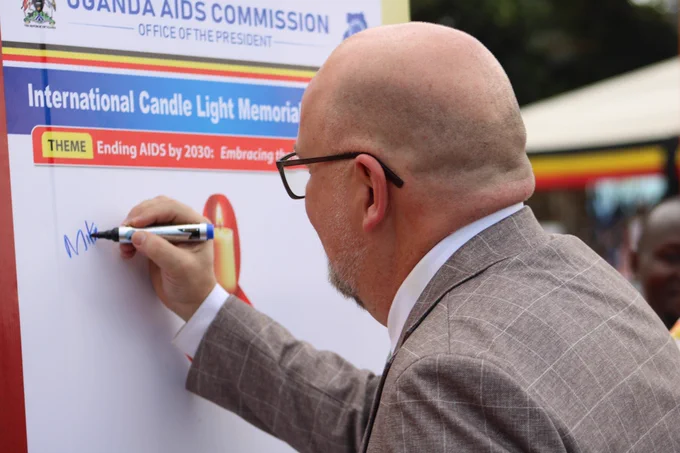 U.S. Embassy Uganda DCM Cleverly signing a placard at the International Candlelight Memorial
