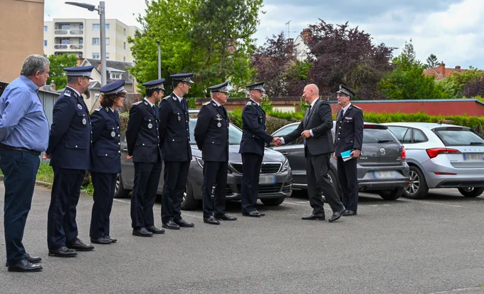 Devant le commissariat : le préfet salue un à un les policiers en uniforme, en rang.