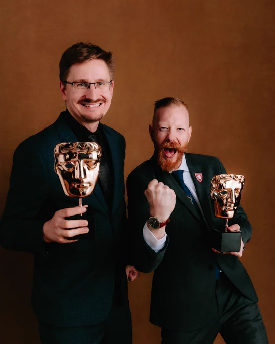 Prokop Jirsa (left) and Tobias Stolz-Zwilling (right) photographed backstage at the BAFTA Games Awards with Google Play 2026. They hold BAFTAs. Prokop smiles and Tobias cheers and pumps his fist.