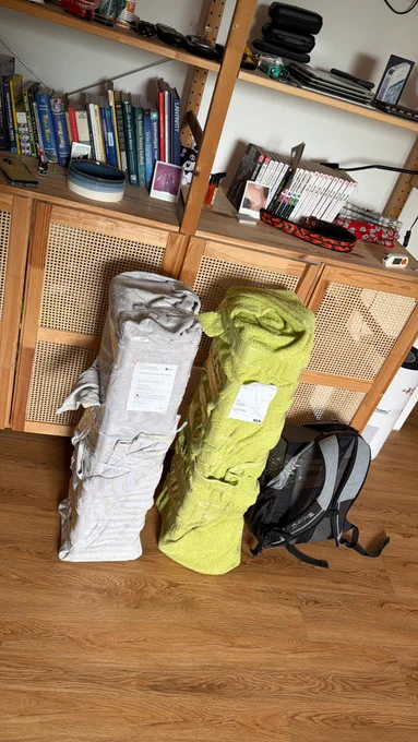 the same two large boxes in towels and a backpack with an av receiver on the floor