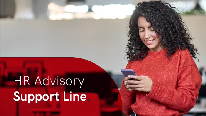 Person in a red sweater using a smartphone with a blurred office background.  In the lower left is a semi-opaque curved red overlay with the words 'HR Advisory Support Line' in white text.