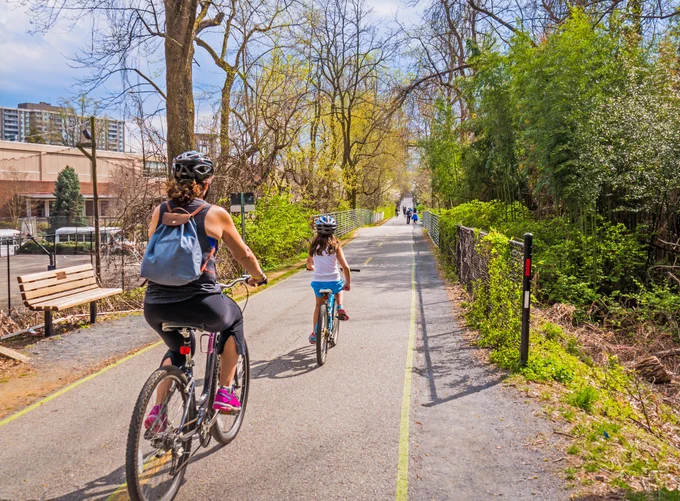 Image of a mother and daughter biking on a trail.