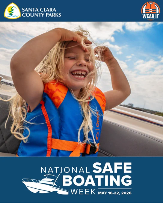 A graphic of a young girl wearing a life jacket smiling with her blond hair flying as she sits in a boat. The text reads – National Safe Boating Week May 16-22, 2026.