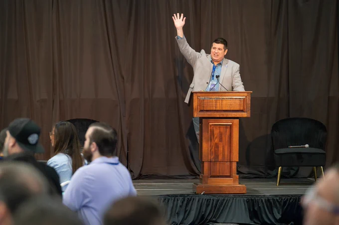 Image of Chris Diniz speaking at podium during the NextTech Kern conference in 2025