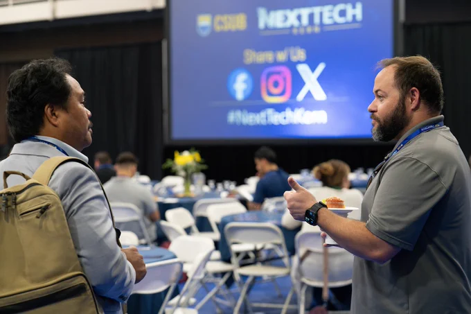 Image of faculty members talking during the NextTech Kern event in 2025. 