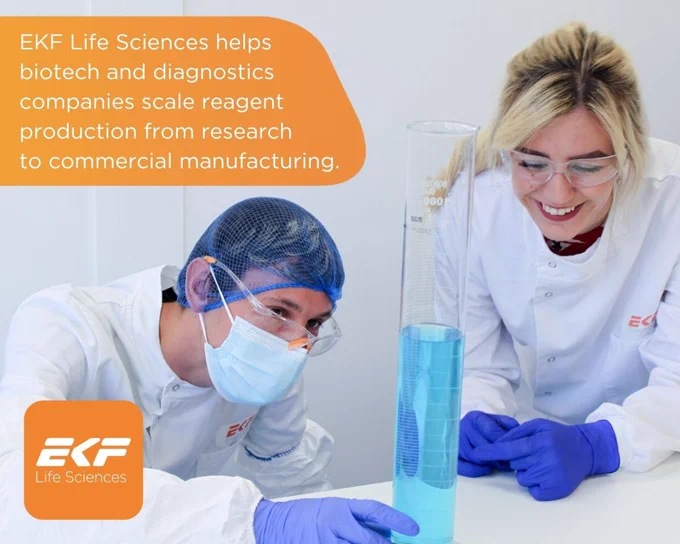 Two scientists in lab coats and gloves examining a tall graduated cylinder filled with blue liquid in a laboratory setting.
Text: "EKF Life Sciences helps biotech and diagnostics companies scale reagent production from research to commercial manufacturing".