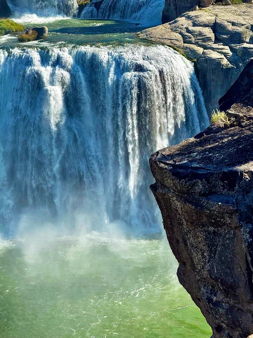 Shoshone waterfall from perspective of large rock. Beautiful flowing waterfall with crystal water below in Rocky landscape. Photographic art.