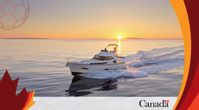 Luxury motor yacht cruising on calm waters at sunset with a clear sky and distant horizon.