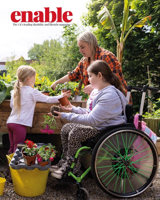 An image of a family, a mum and two girls, spending time in their garden together. One of the girls is using a wheelchair while repotting a plant.