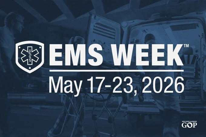 Promotional graphic for EMS Week 2026. Dark blue-toned photo shows emergency medical personnel loading a patient on a stretcher into an open ambulance. On the left is the white EMS shield logo with the Star of Life symbol. Large white text reads: EMS WEEK™ May 17-23, 2026. Wisconsin Assembly GOP logo is in the bottom right corner.