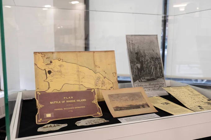 display case with old map, photo from revolutionary war, and other documents