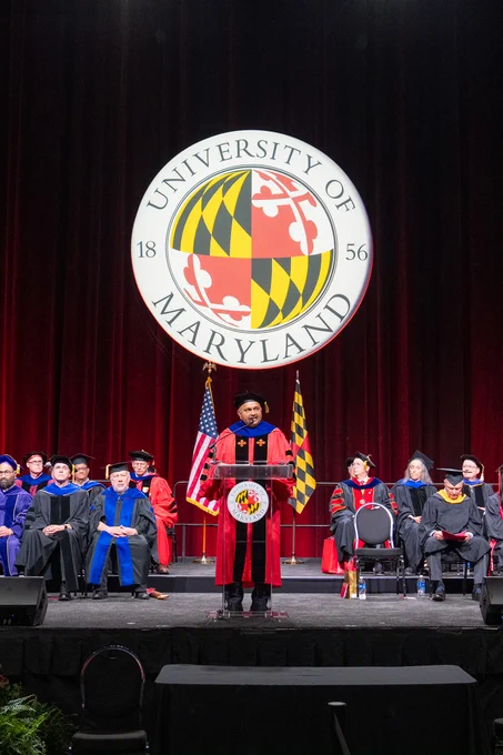 Dean Amitabh Varshney standing behind a lectern under a large University of Maryland seal sign 