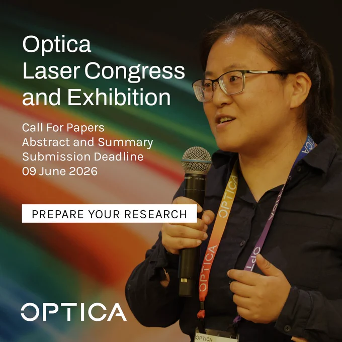 An individual speaking at the Optica Laser Congress and Exhibition, holding a microphone. The background features vibrant colors and text details: "Call For Papers. Abstract and Summary Submission Deadline 09 June 2026." The person wears a lanyard with "OPTICA" printed on it.
