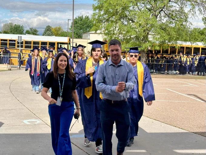 Principal Estrada and Principal Dr. Fox lead the students into the building.