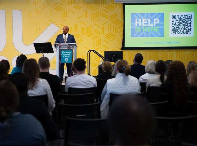 A man presenting at a podium