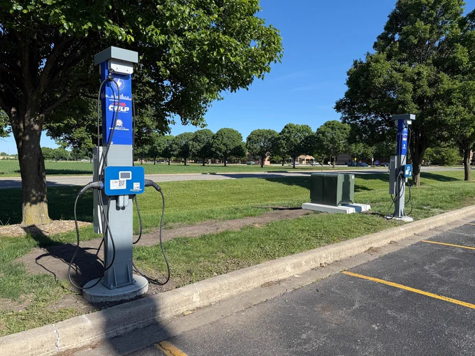 EV charging stations in Lot I North near TRAC on the #UISedu campus under a clear blue sky.