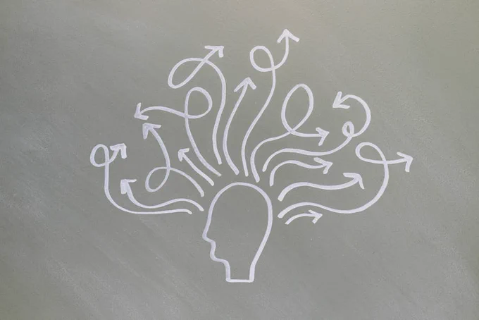 Conceptual chalk drawing illustrating mental health challenges with arrows representing thoughts.